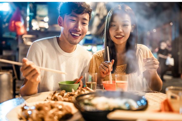 Couple eating street food in Hong Kong